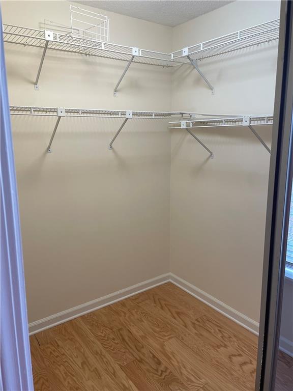 spacious closet with wood finished floors