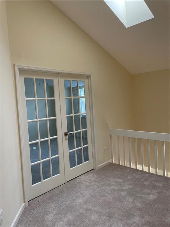 interior space featuring french doors, lofted ceiling with skylight, and carpet