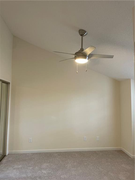 unfurnished room featuring light carpet, high vaulted ceiling, a ceiling fan, and baseboards