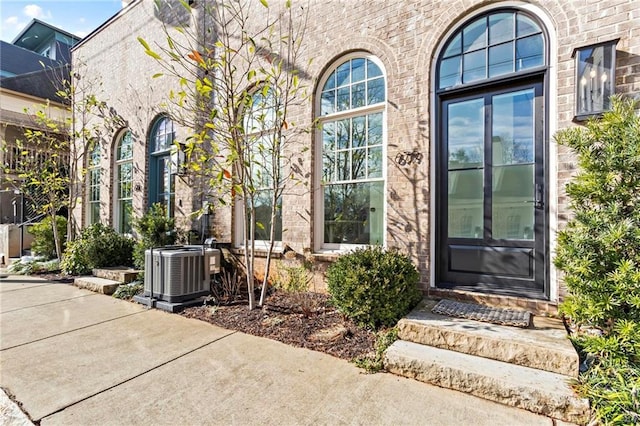 doorway to property featuring a patio area and central AC unit