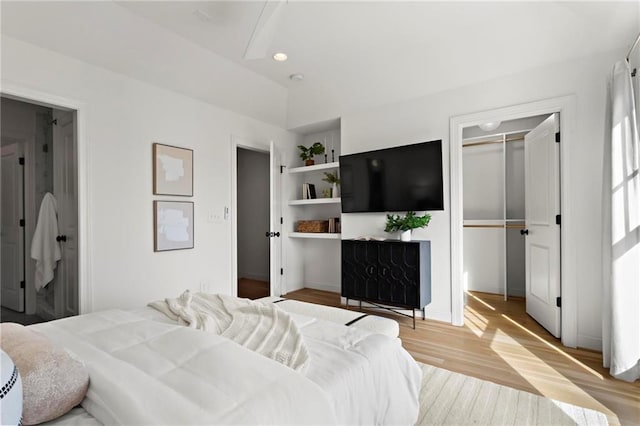 bedroom with light hardwood / wood-style flooring and a closet