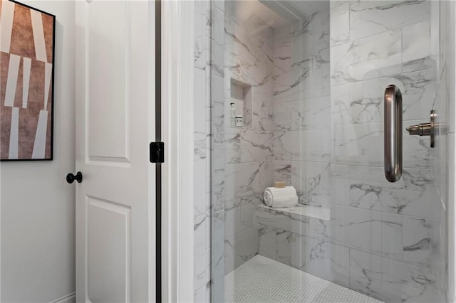 bathroom with a shower with door