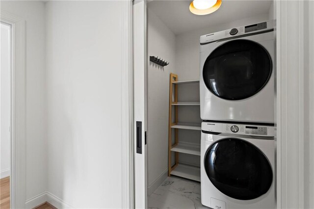 laundry room featuring stacked washer / drying machine