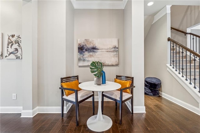 dining space with baseboards, stairs, breakfast area, and wood finished floors