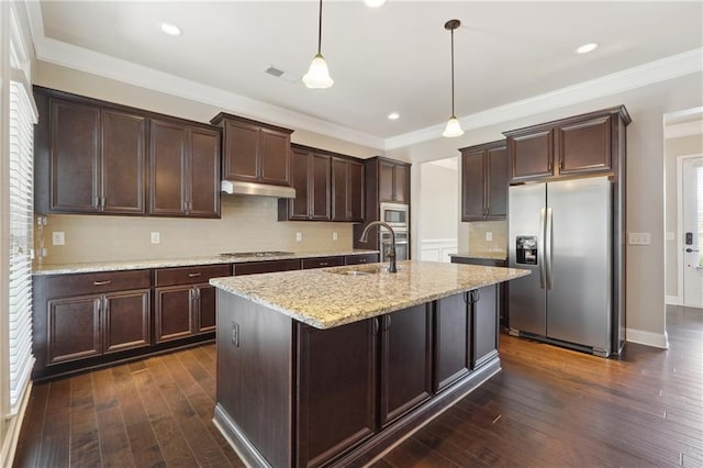 kitchen featuring dark wood-type flooring, stainless steel appliances, dark brown cabinets, under cabinet range hood, and a sink