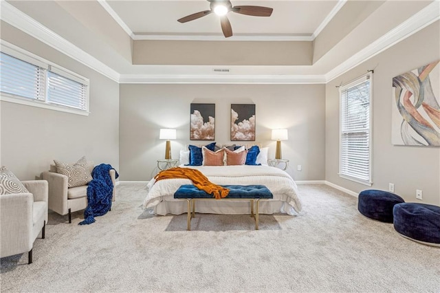 bedroom featuring a tray ceiling, visible vents, crown molding, and carpet