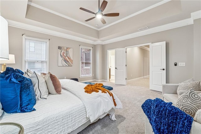 bedroom featuring a raised ceiling, ornamental molding, carpet flooring, ceiling fan, and baseboards