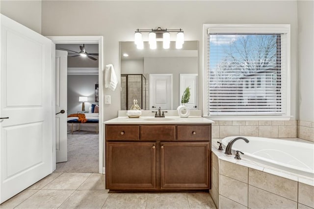 full bath with ensuite bathroom, a garden tub, tile patterned flooring, vanity, and a shower stall