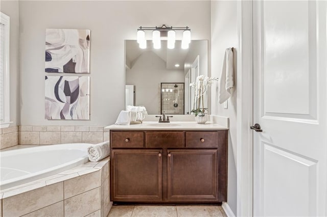 full bath featuring a garden tub, tile patterned flooring, tiled shower, and vanity