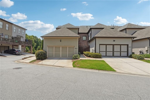 view of front facade featuring a garage, driveway, and a residential view