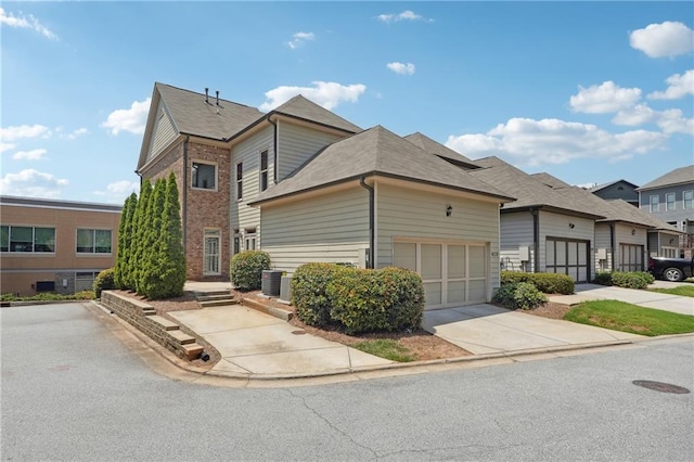 view of front of home with a garage, driveway, and brick siding