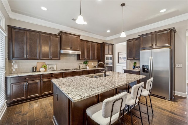 kitchen featuring stainless steel appliances, dark wood-type flooring, a sink, and under cabinet range hood