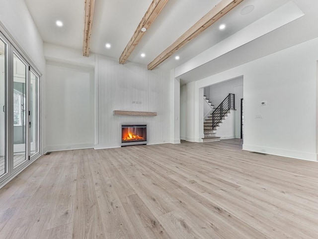 356 Henry Scott Rd, Ball Ground, GA 30107 - unfurnished living room with light wood-style flooring, beam ceiling, stairs, a fireplace, and recessed lighting