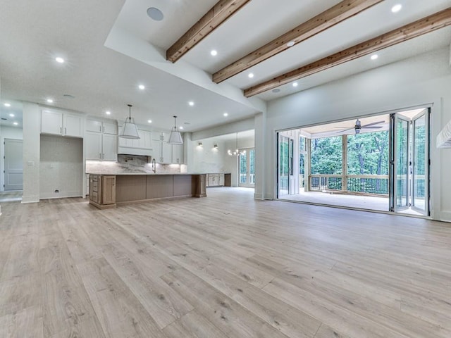 356 Henry Scott Rd, Ball Ground, GA 30107 - unfurnished living room with beamed ceiling, recessed lighting, light wood finished floors, and a sink