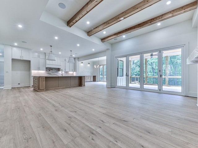 356 Henry Scott Rd, Ball Ground, GA 30107 - unfurnished living room with beam ceiling, recessed lighting, light wood-type flooring, and french doors