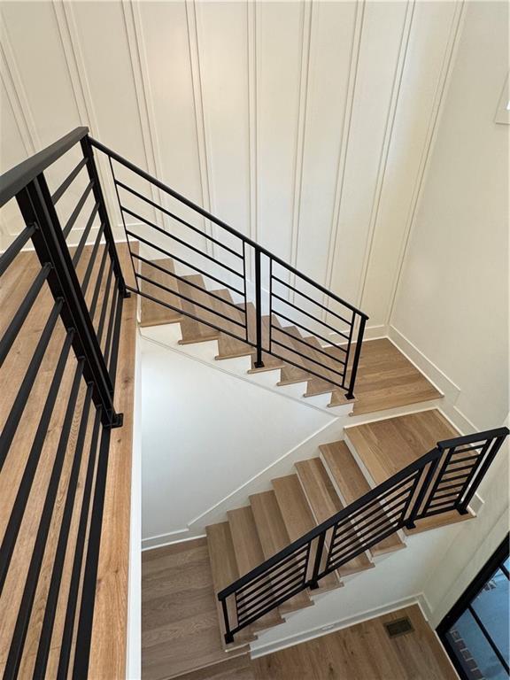 356 Henry Scott Rd, Ball Ground, GA 30107 - stairs with wood finished floors and a decorative wall