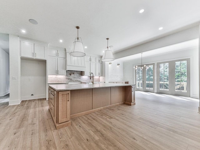 356 Henry Scott Rd, Ball Ground, GA 30107 - kitchen featuring decorative backsplash, recessed lighting, light wood-type flooring, a sink, and a spacious island