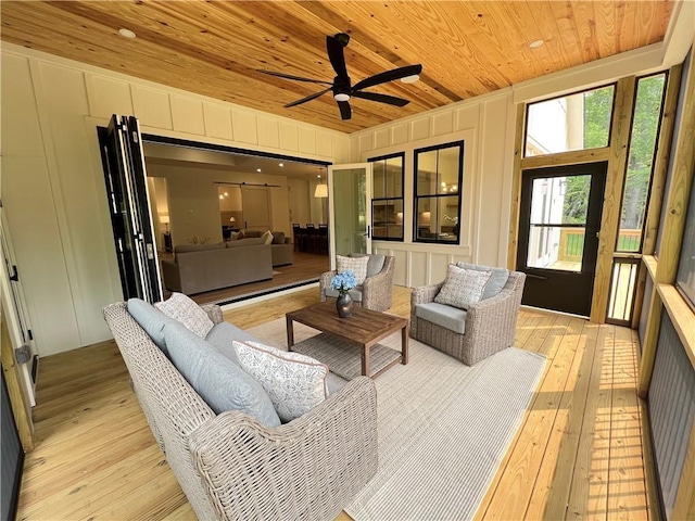 356 Henry Scott Rd, Ball Ground, GA 30107 - living area with wood ceiling, light wood-style floors, a ceiling fan, and a decorative wall