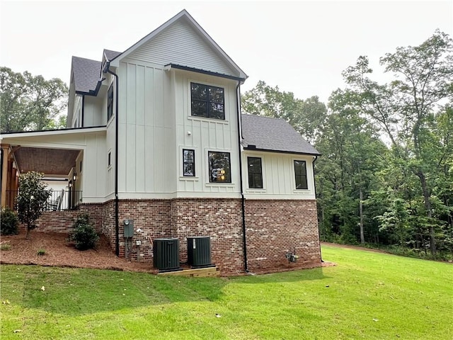 356 Henry Scott Rd, Ball Ground, GA 30107 - view of property exterior featuring a yard, board and batten siding, brick siding, and central AC