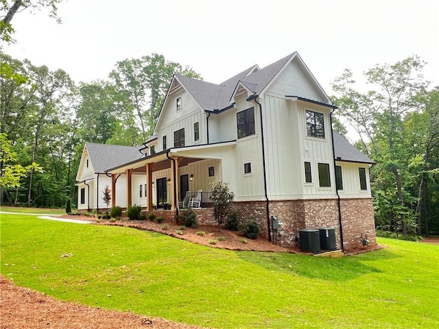 356 Henry Scott Rd, Ball Ground, GA 30107 - back of house featuring board and batten siding, a lawn, central AC, and covered porch