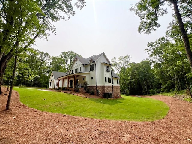356 Henry Scott Rd, Ball Ground, GA 30107 - rear view of property featuring a yard, central AC, board and batten siding, and brick siding