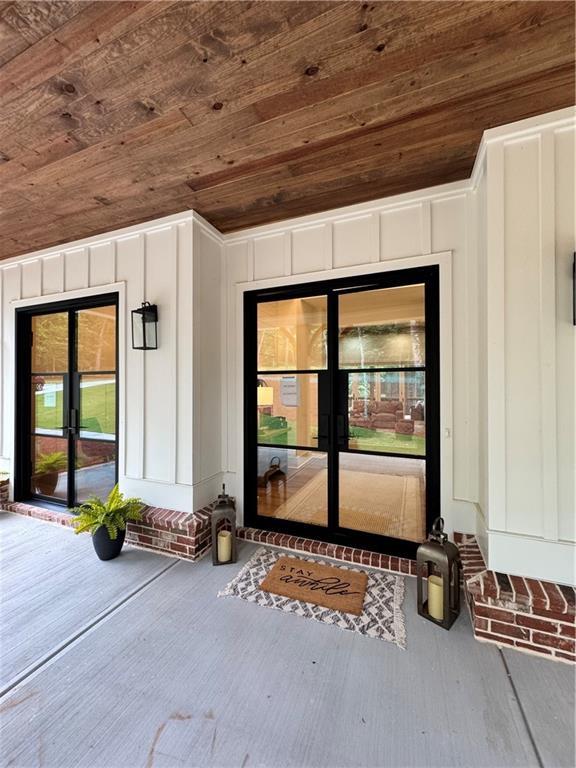 356 Henry Scott Rd, Ball Ground, GA 30107 - doorway to property with french doors and board and batten siding
