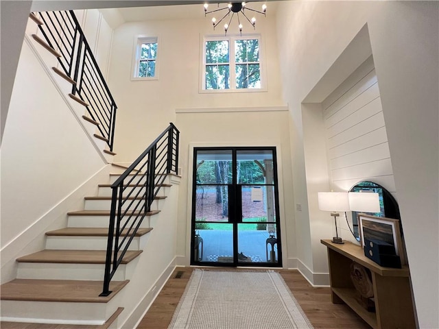 356 Henry Scott Rd, Ball Ground, GA 30107 - foyer with wood finished floors, stairway, a chandelier, healthy amount of natural light, and a towering ceiling