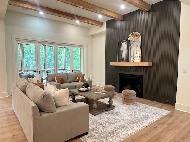 356 Henry Scott Rd, Ball Ground, GA 30107 - living room with beamed ceiling, healthy amount of natural light, light wood-style flooring, baseboards, and a large fireplace