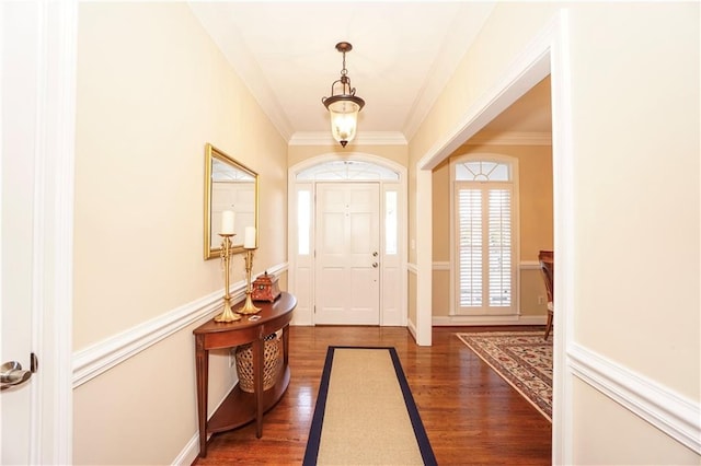 entrance foyer with dark hardwood / wood-style flooring and ornamental molding