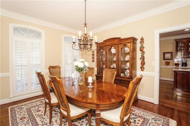 dining room featuring a chandelier, crown molding, plenty of natural light, and dark wood-type flooring