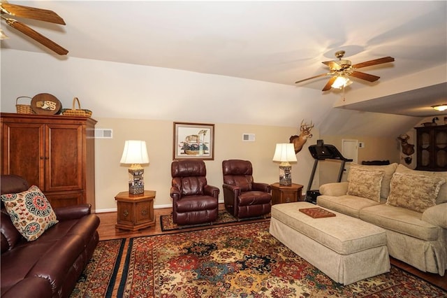 living room featuring ceiling fan, hardwood / wood-style floors, and vaulted ceiling