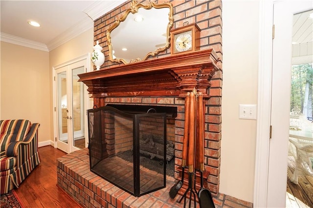 room details featuring a fireplace, french doors, hardwood / wood-style flooring, and ornamental molding