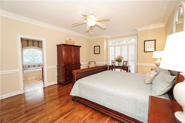 bedroom with hardwood / wood-style floors, ceiling fan, and crown molding