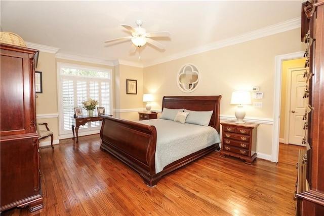 bedroom with ceiling fan, crown molding, and dark wood-type flooring