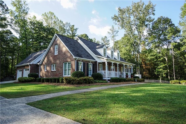 cape cod house featuring covered porch, a garage, and a front yard