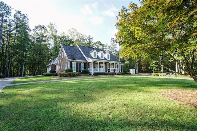 cape cod house with a front lawn and a porch