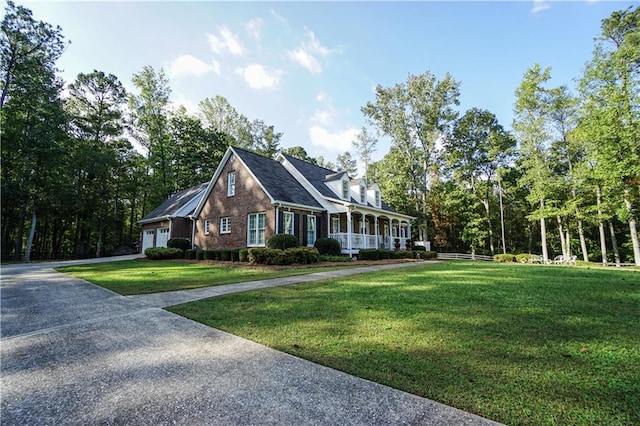 cape cod home with a porch, a garage, and a front yard