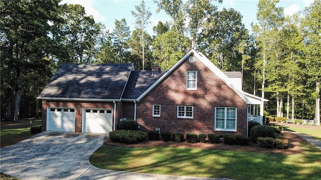 view of front of property with a garage and a front yard