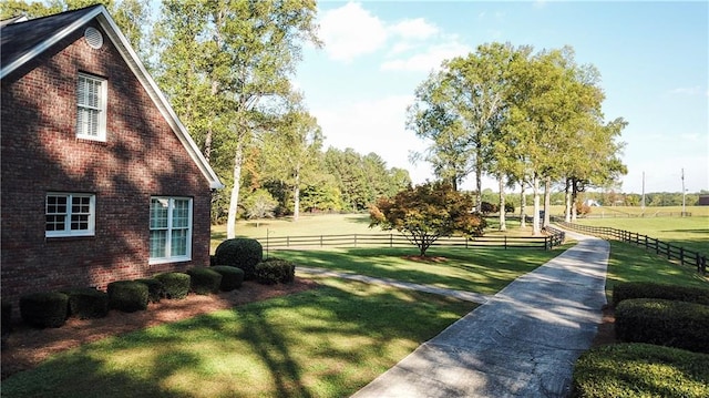 exterior space featuring a lawn and a rural view