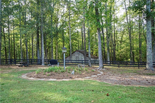 view of property's community with an outdoor structure and a yard