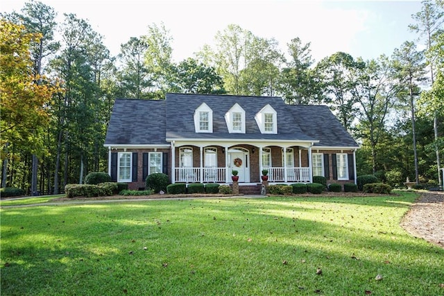 cape cod home featuring a front lawn and a porch