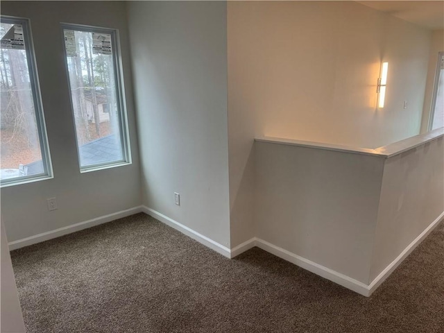 unfurnished room featuring baseboards and carpet flooring