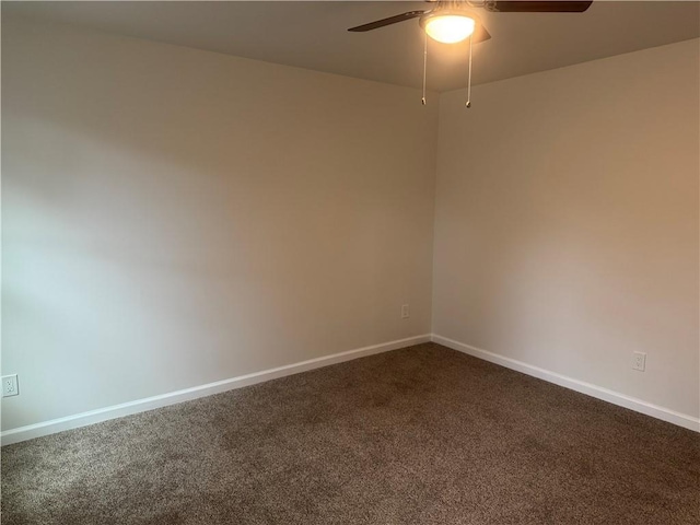 unfurnished room featuring ceiling fan, baseboards, and dark colored carpet