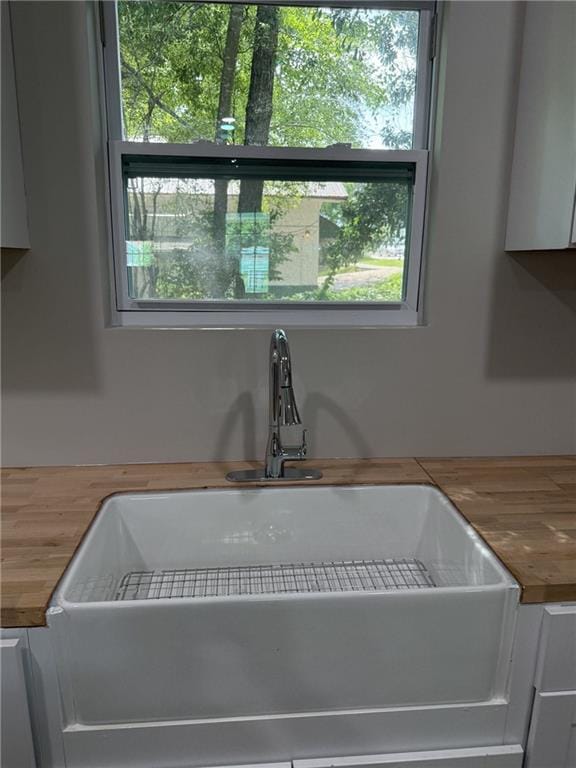 1300 Murphy Ave, Lagrange, GA 30240 - kitchen view of wooden counters, a sink, and white cabinetry