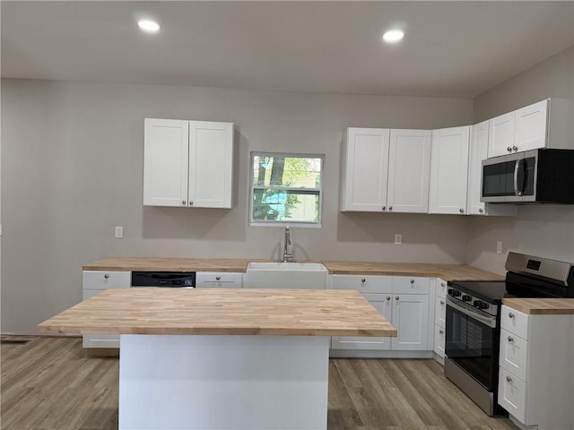 1300 Murphy Ave, Lagrange, GA 30240 - kitchen with wood counters, stainless steel appliances, a sink, light wood-style flooring, and recessed lighting