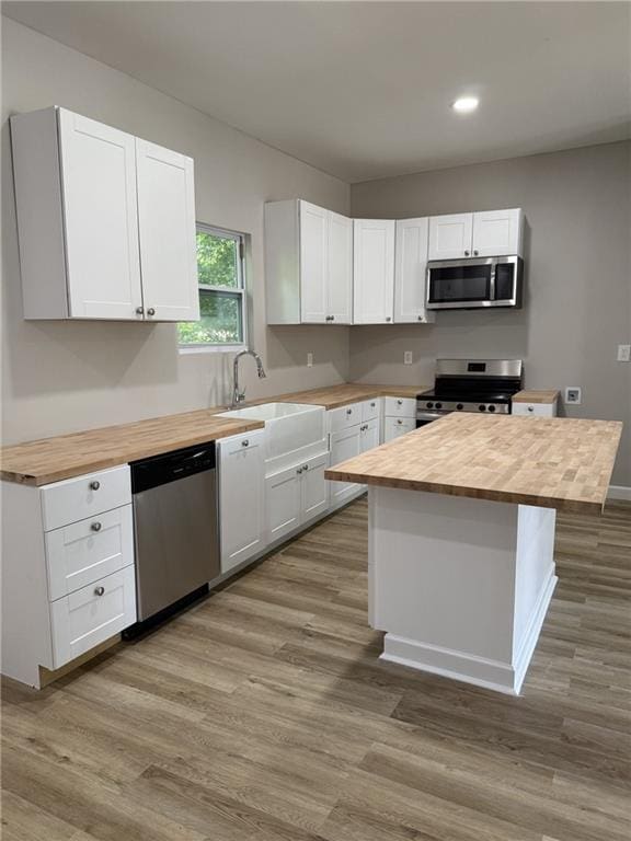 1300 Murphy Ave, Lagrange, GA 30240 - kitchen featuring butcher block counters, appliances with stainless steel finishes, wood finished floors, and recessed lighting