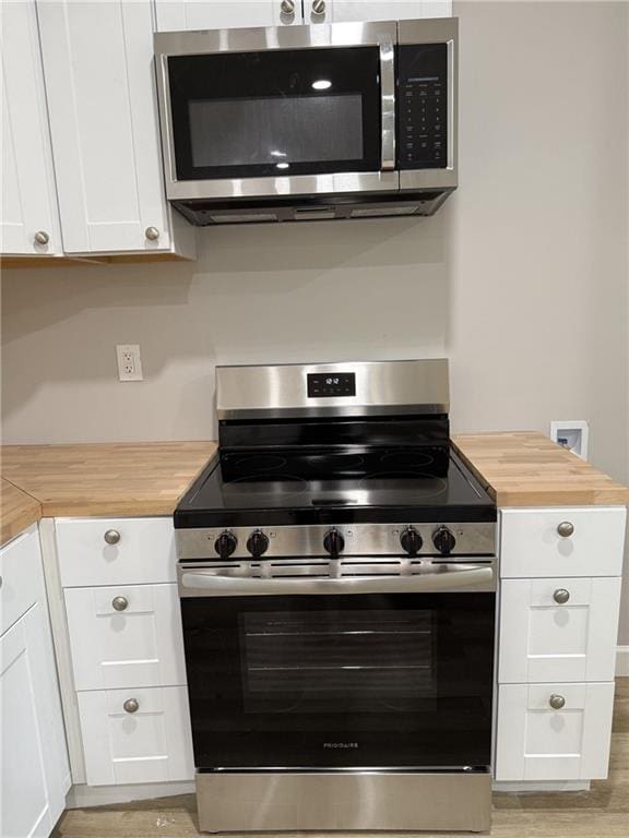 1300 Murphy Ave, Lagrange, GA 30240 - kitchen featuring appliances with stainless steel finishes, wood counters, white cabinetry, and light wood-style floors