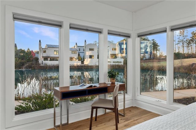 sunroom with a water view and a healthy amount of sunlight