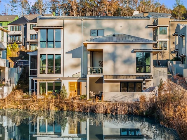 rear view of house featuring a water view