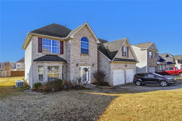 view of front of house with central AC unit, a garage, and a front lawn